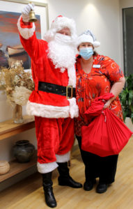 Father Christmas with felicity Tucker, dressed in red with a sack of presents