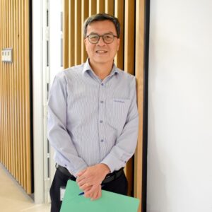 Resthaven Manager Finance, Jeremy Ong, stands at Resthaven Head Office