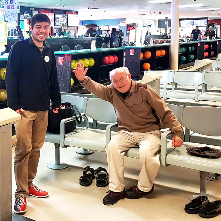 Young and older men at bowling together
